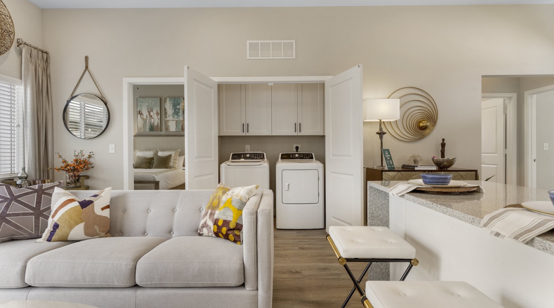 living room with seating and washer and dryer in a closet