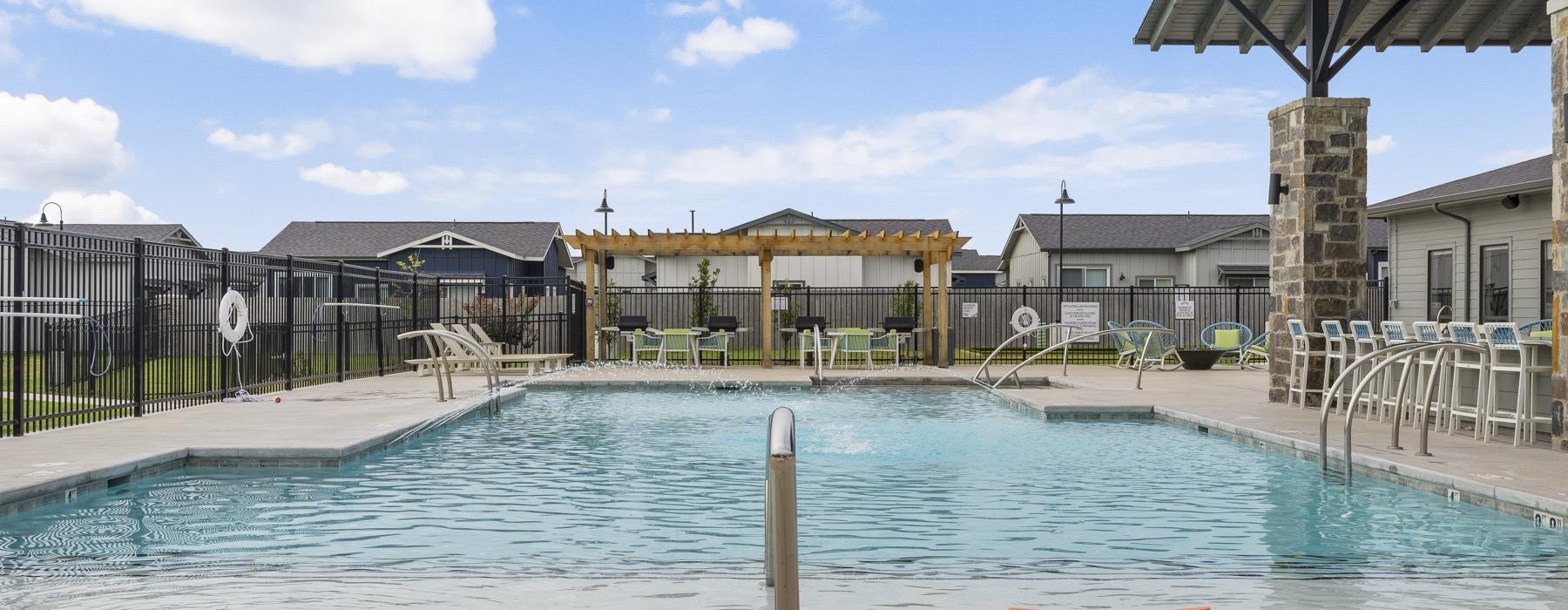 a swimming pool with a building in the background