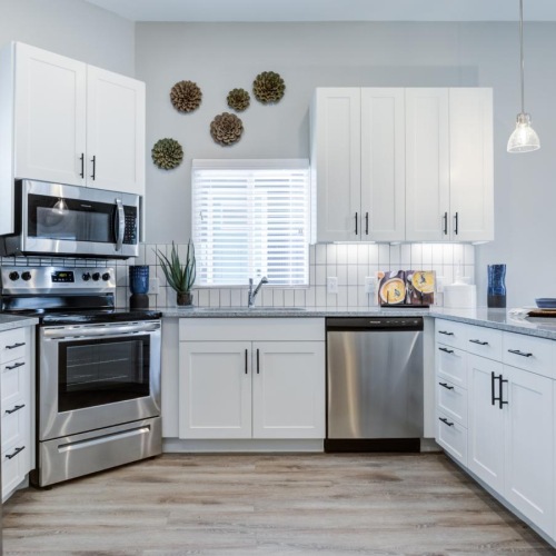 a kitchen with white cabinets