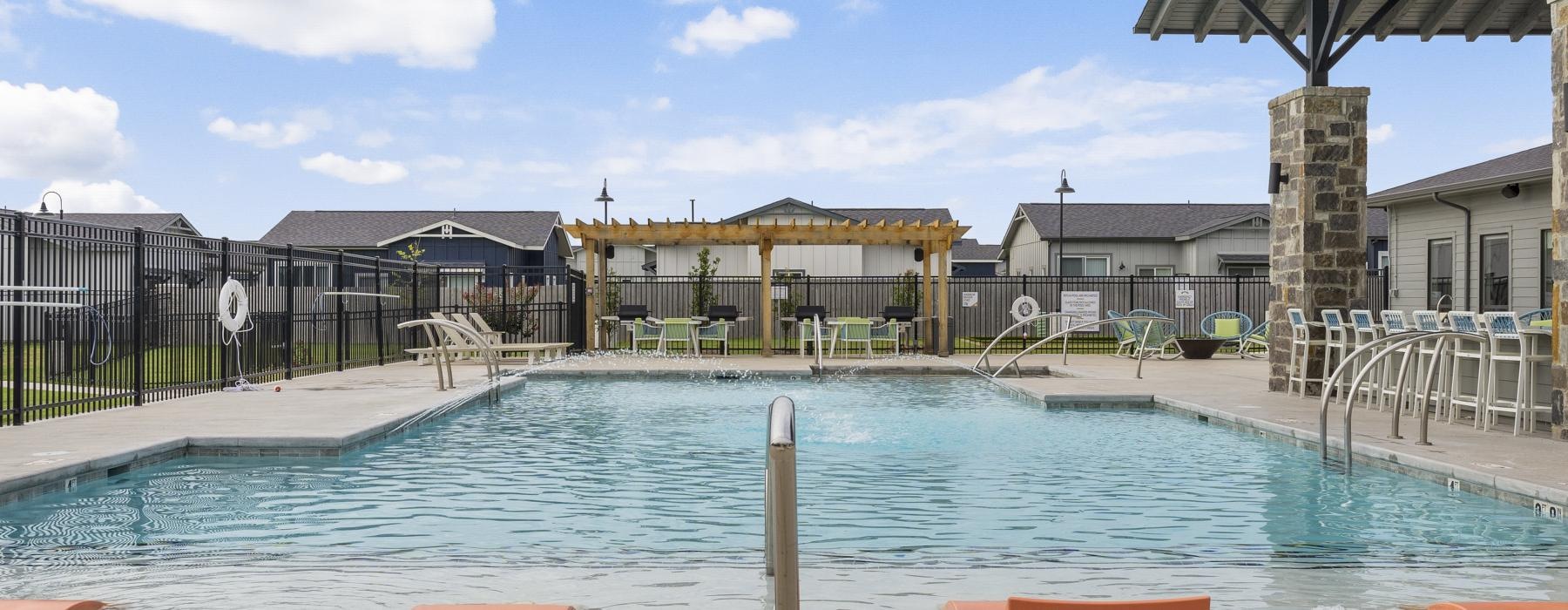 a swimming pool with a building in the background