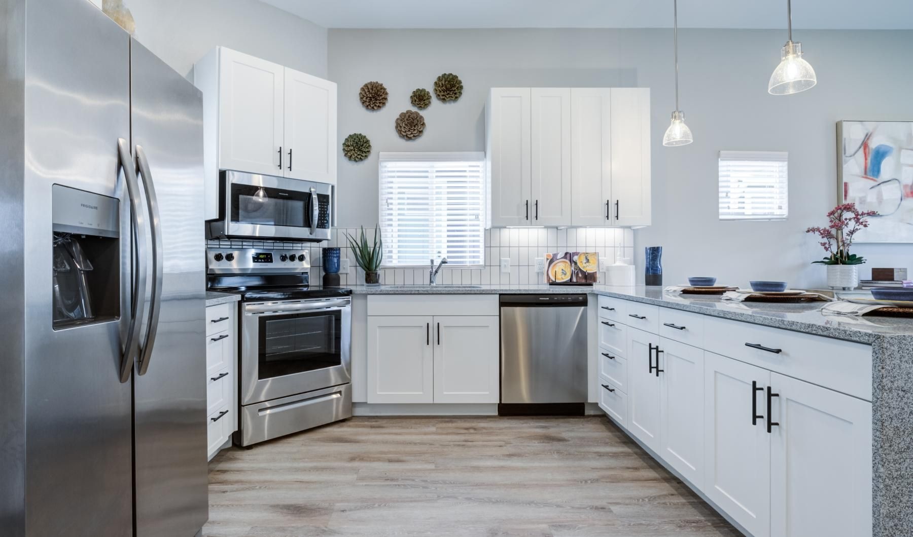 a kitchen with white cabinets